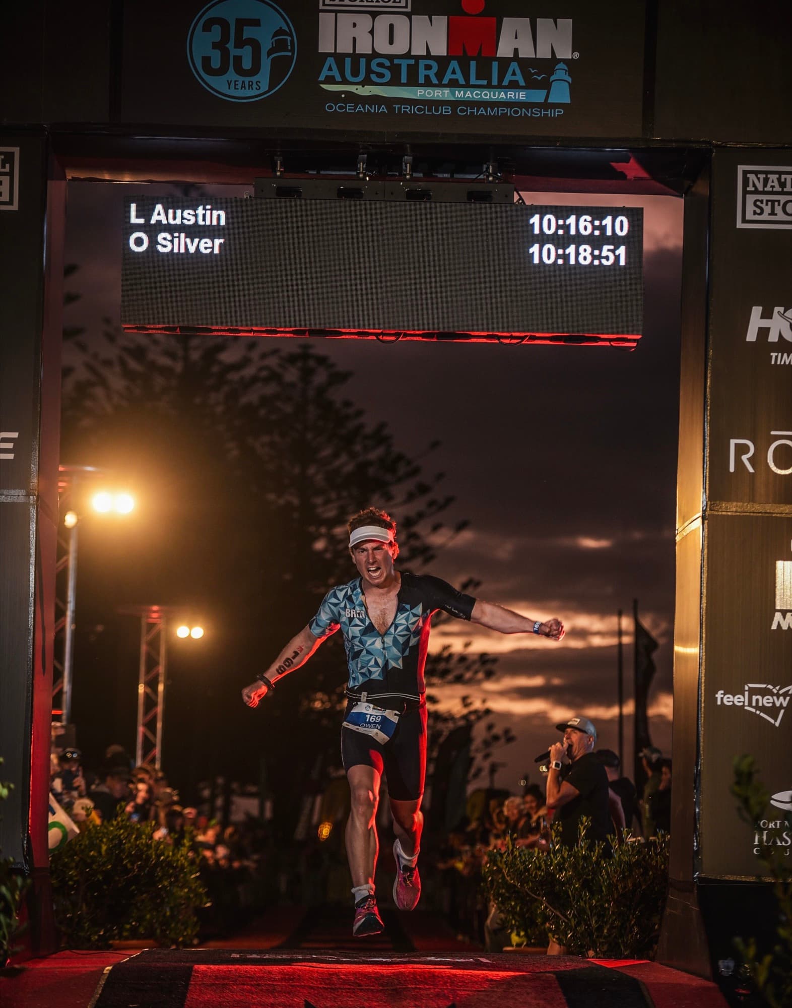 Owen celebrating as he crosses the Ironman Australia finish line in 10:18:51