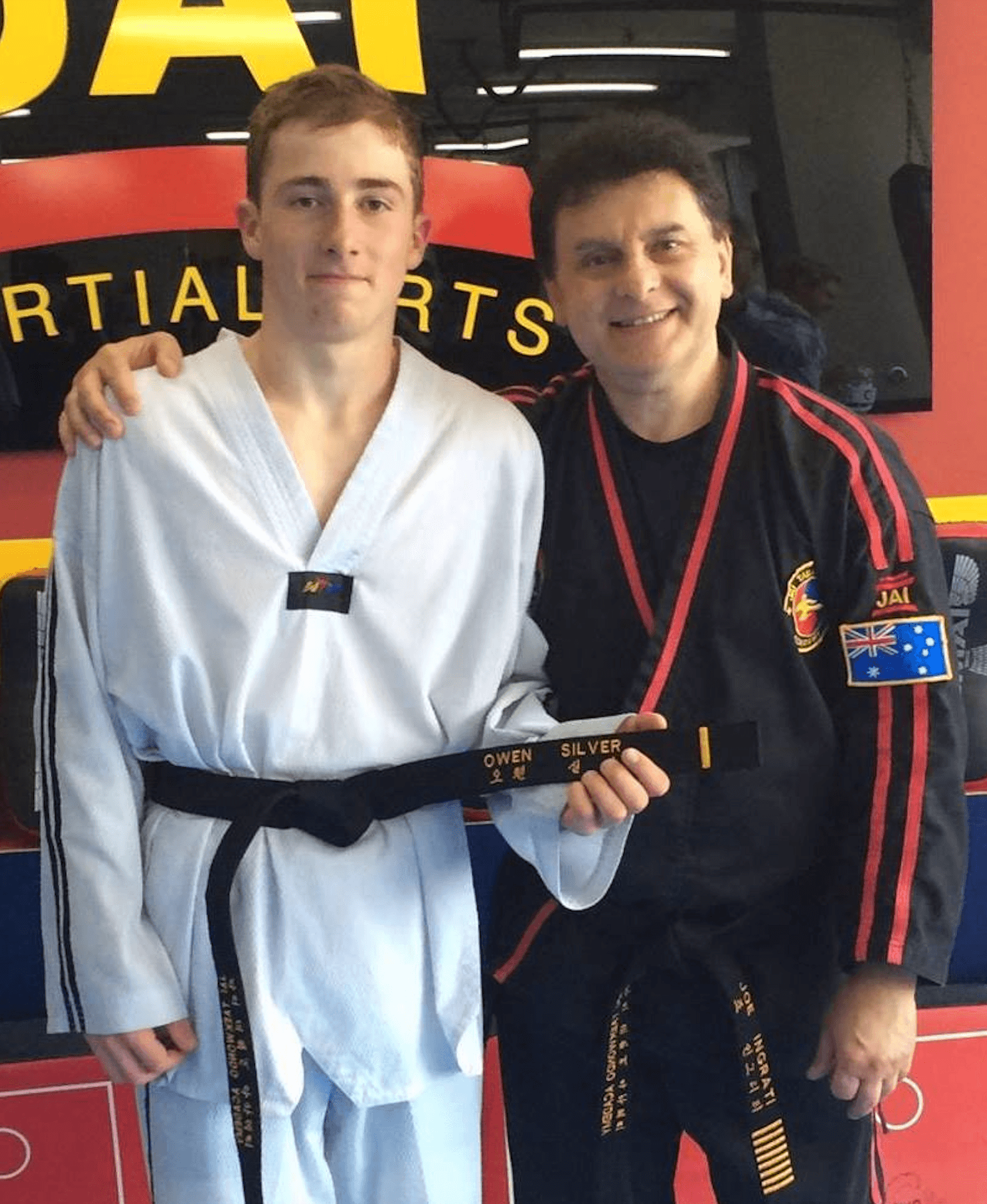 Owen receiving his Taekwondo black belt from his instructor